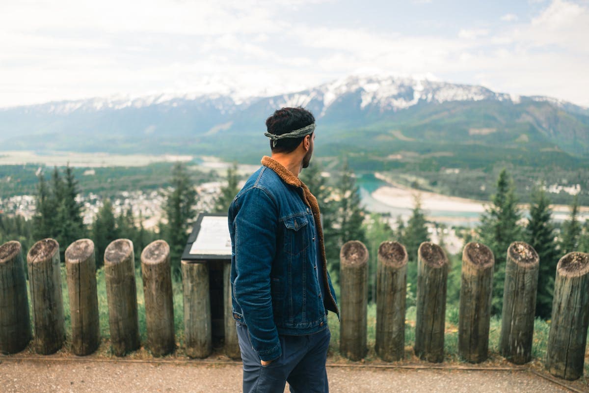 Scenic mountain viewpoint overlooking Revelstoke with snow-capped Selkirk Mountain peaks