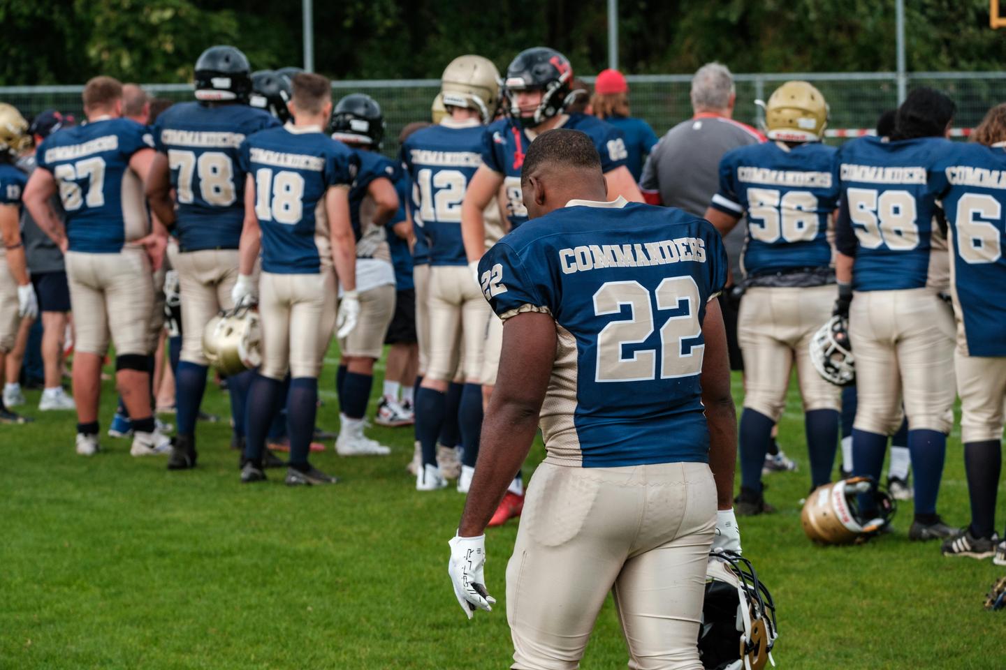 Football team players in uniforms on the field preparing for game day